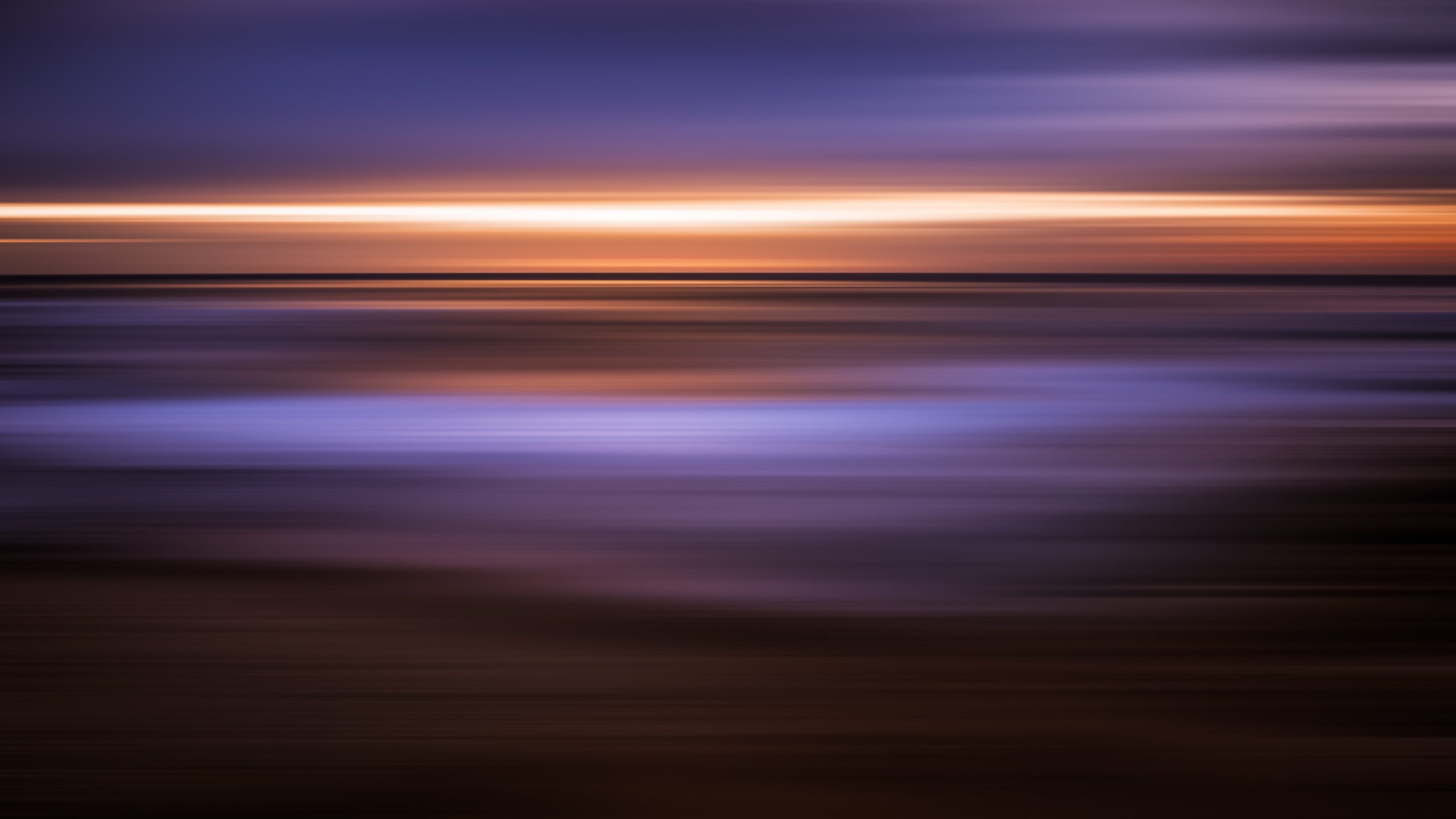Long exposure of a sunset sky rendered as horizontal bands of purple, orange and gold.
August Sunset in Motion by Haressh Vibhakkar