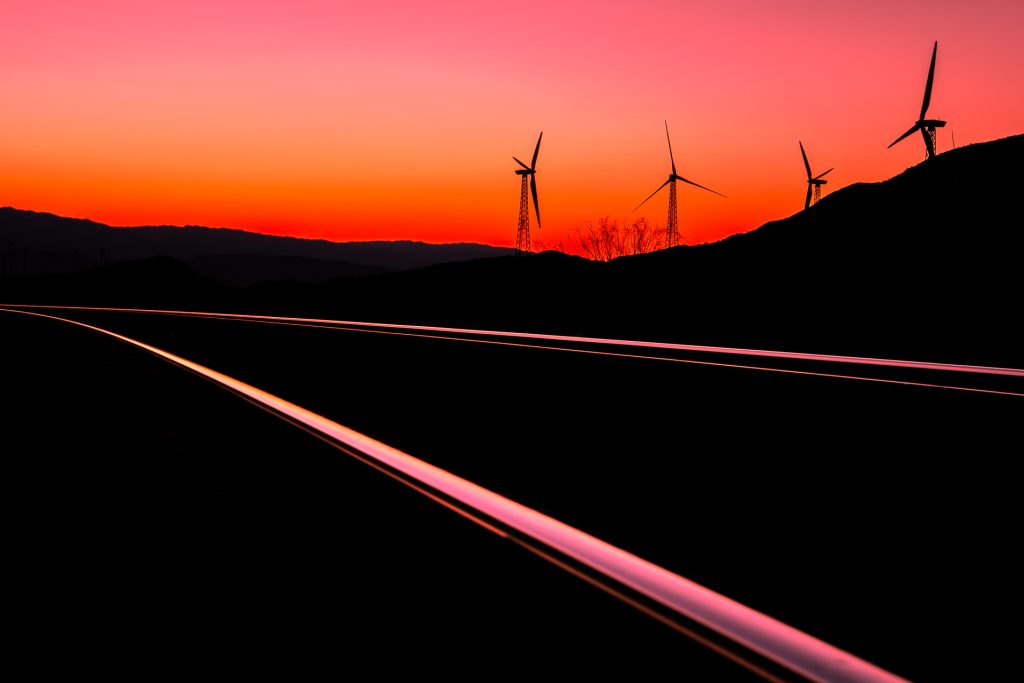 Long-exposure vehicle light trails on a desert highway before dawn
Sunrise on I-10 by Zachary Daly