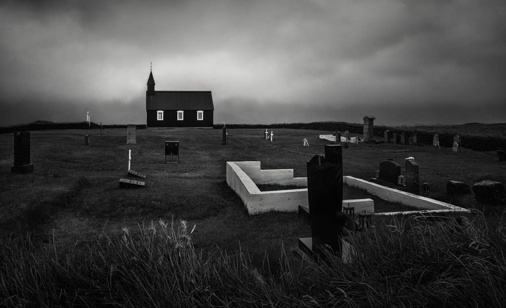 A small dark church alone in an open field
The Black Church by Lisa Miller